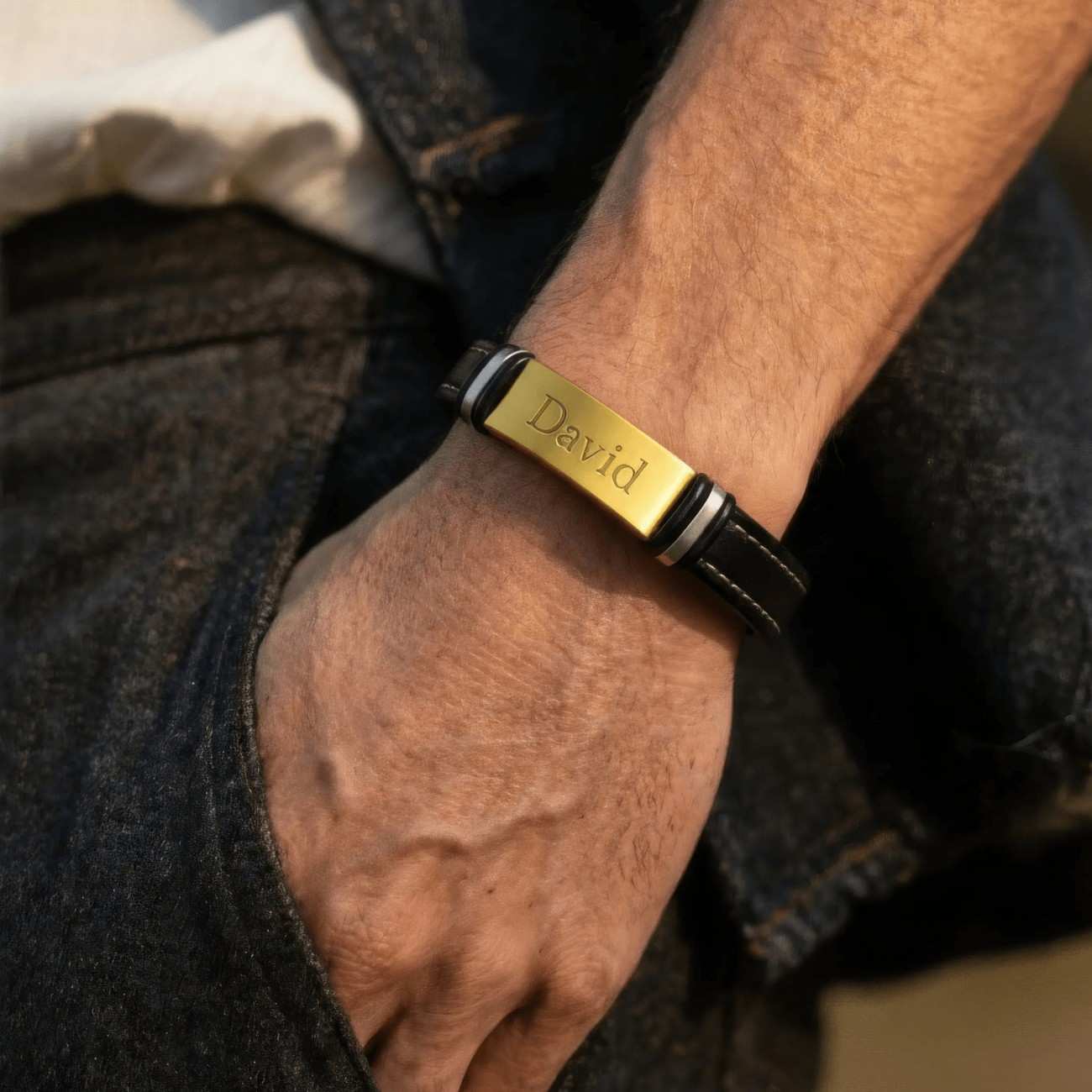 Man wearing personalized gold engraved leather bracelet